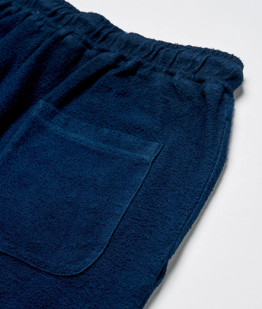 Close-up detail shot of a soft, navy blue, brushed cotton sweatpant in a relaxed fit - Industry of All Nations