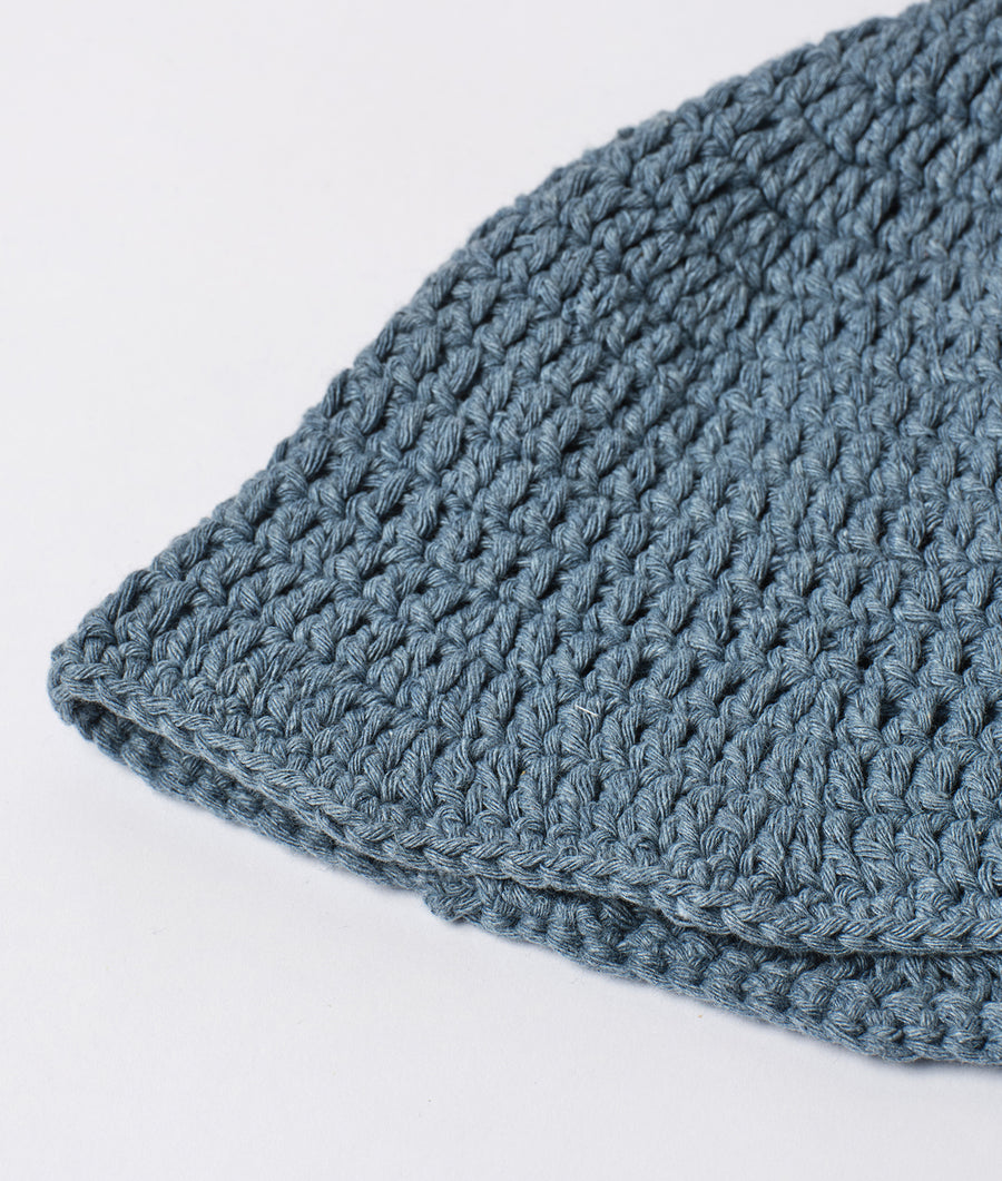 Close-up view of a soft, gray crocheted hat - Industry of All Nations