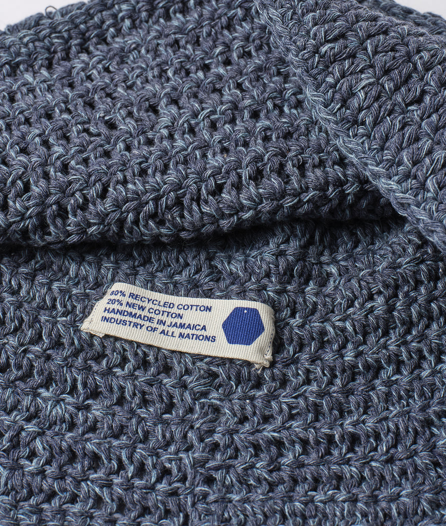 Close-up of a grey crocheted cotton scarf with a "Handmade in Jamaica" tag - Industry of All Nations