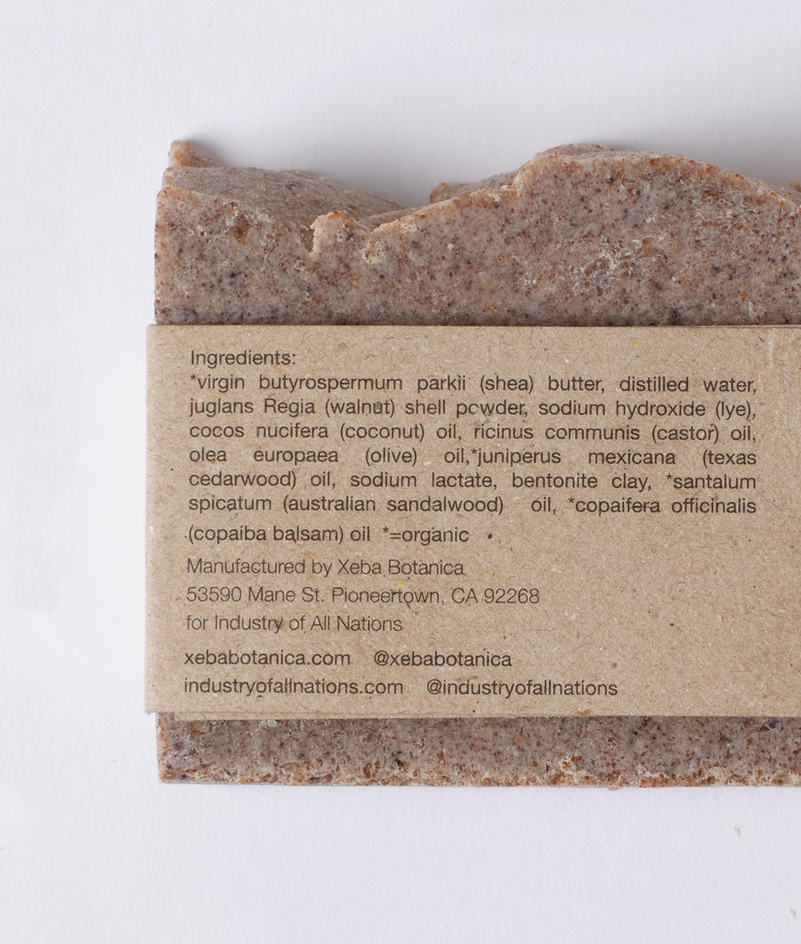 Close-up image of an organic bar soap with detailed ingredient list and manufacturer information - Industry of All Nations