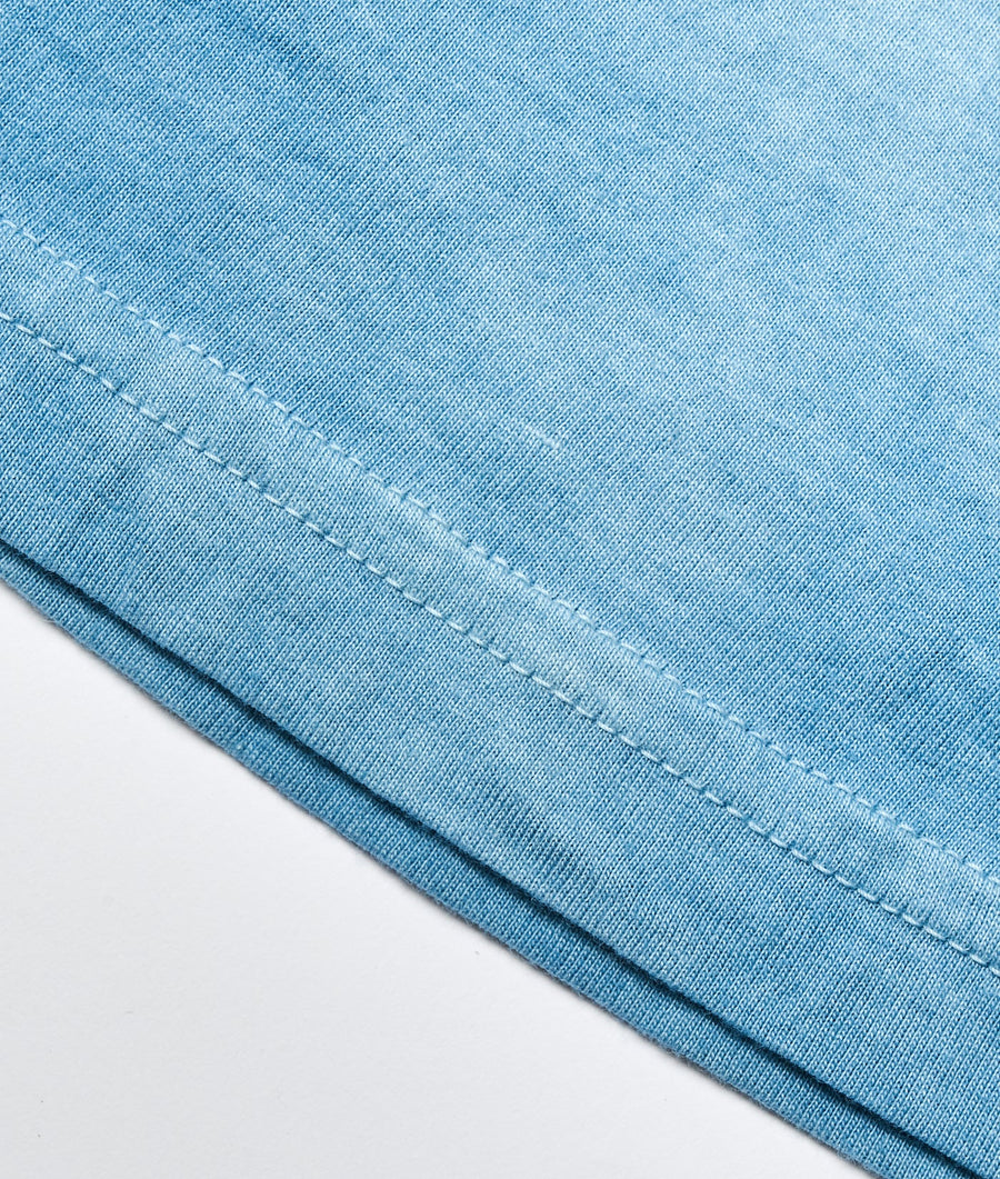 Close-up detail shot of a light blue cotton fabric with stitching details - Industry of All Nations