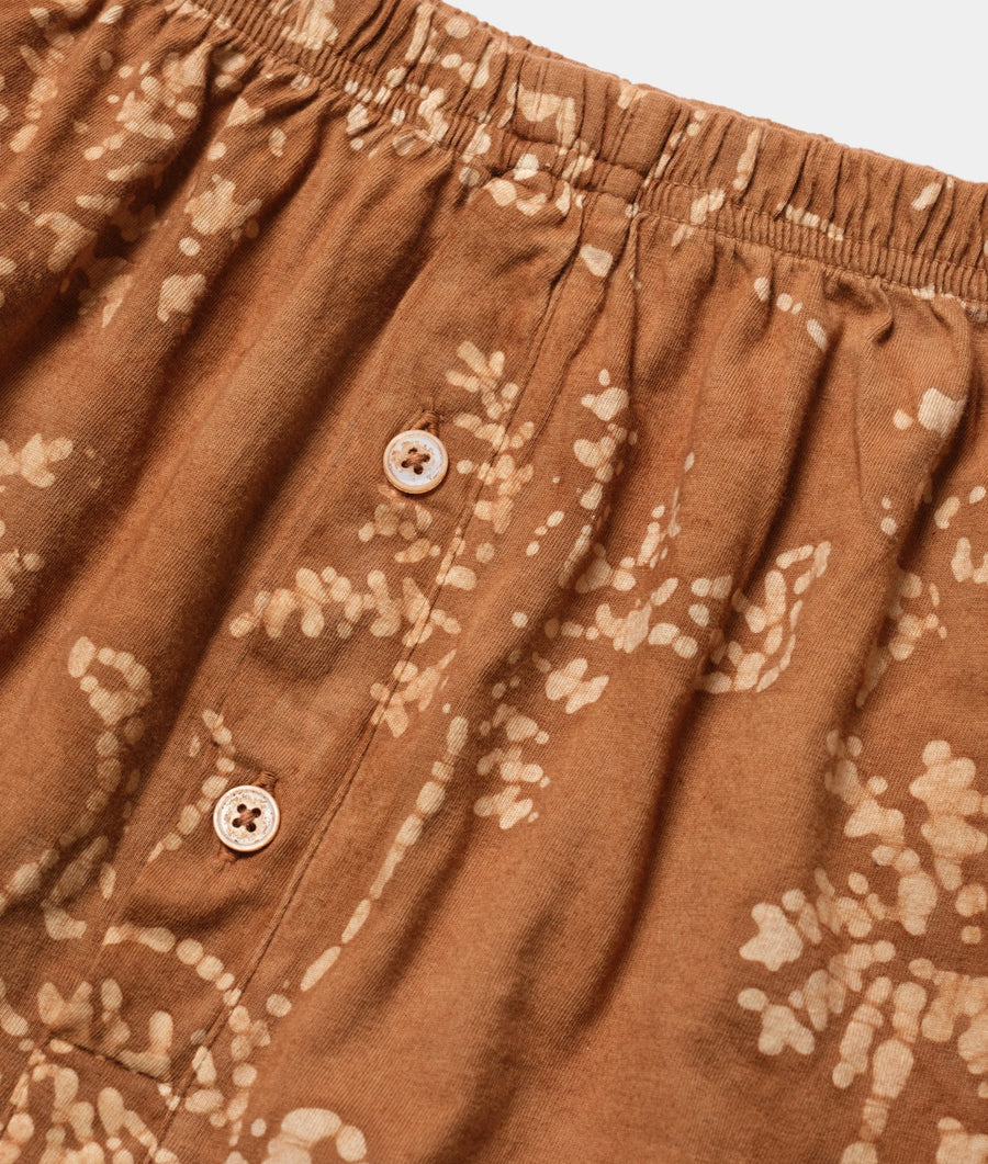 Detailed image of brown corduroy shorts with white floral print, displayed as a flat lay - Industry of All Nations