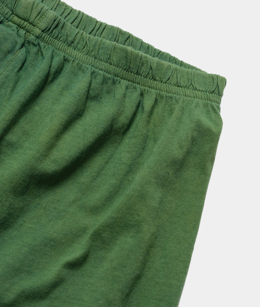 Detail shot of a pair of green organic cotton drawstring shorts - Industry of All Nations