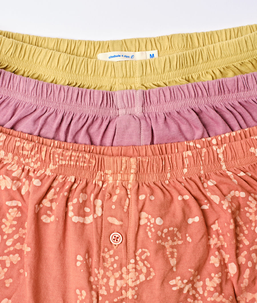 Detail shot of a pink and yellow patterned women's skirt with elastic waistband - Industry of All Nations