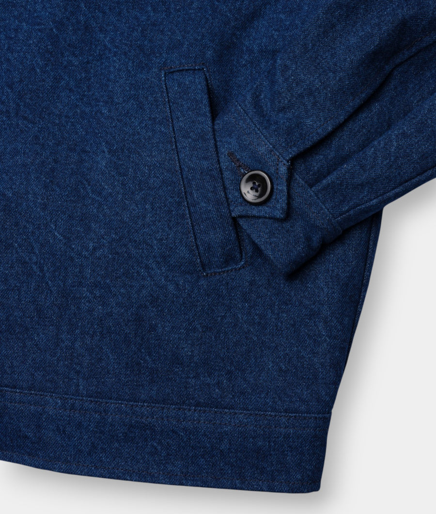Close-up detail shot of a navy blue organic cotton jacket with a single button closure - Industry of All Nations