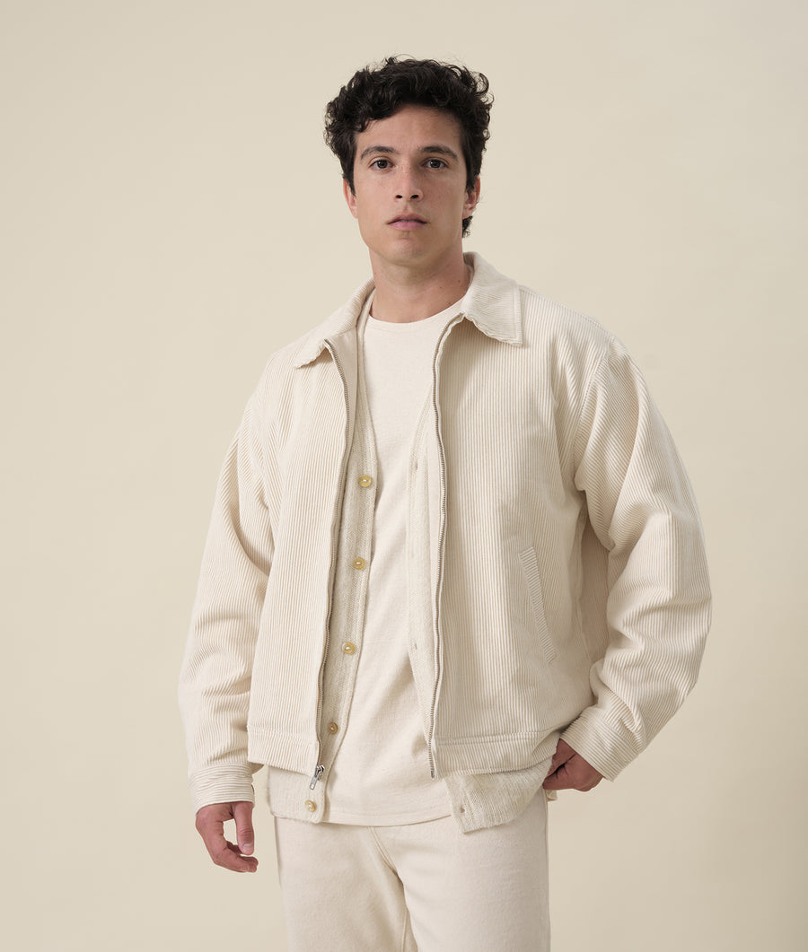 Beige corduroy jacket worn by a model in a neutral-colored studio setting - Industry of All Nations