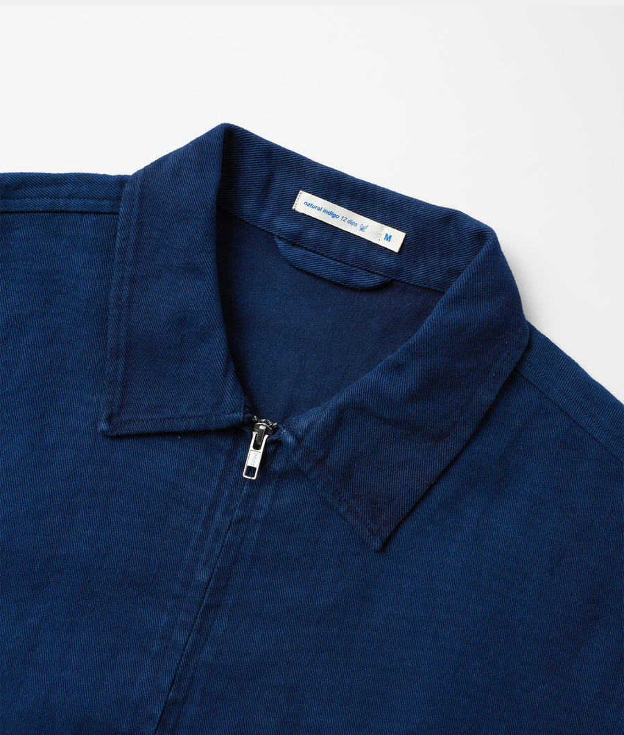 A navy blue, collared jacket made from organic cotton, displayed in a flat lay - Industry of All Nations