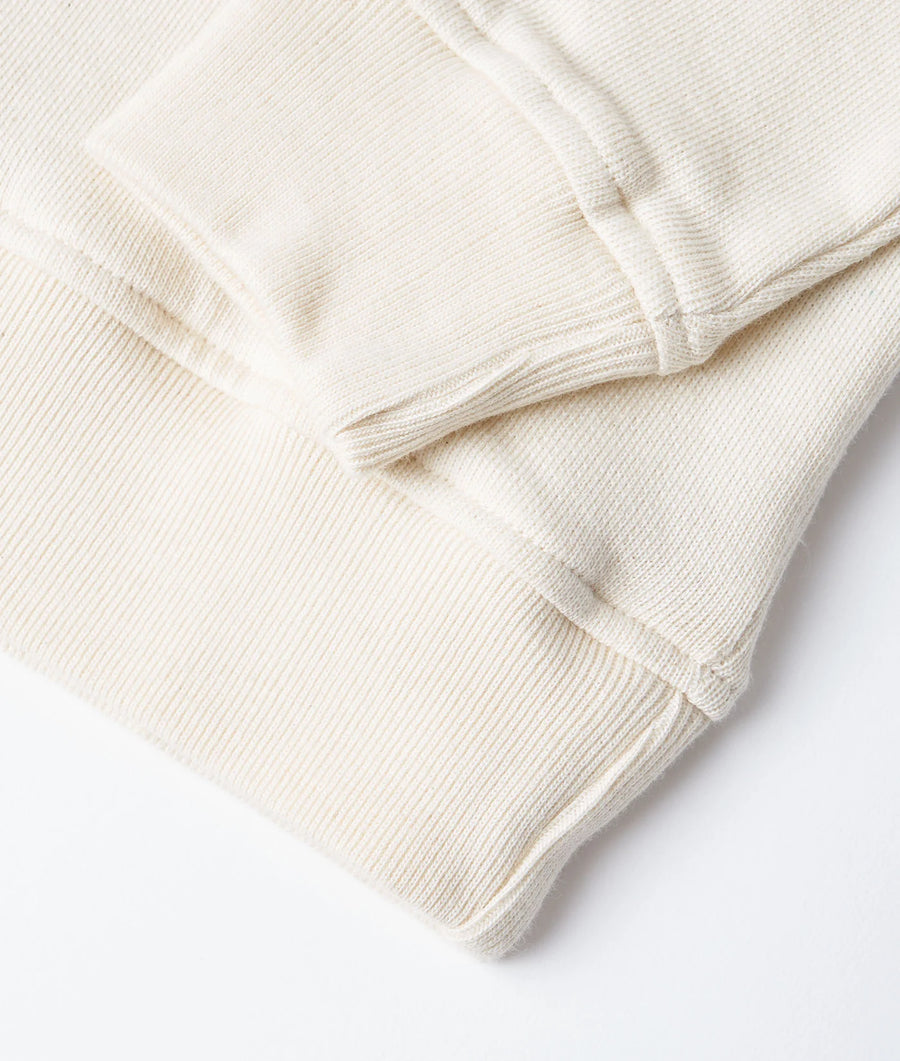 Detail shot of a beige organic cotton pullover - Industry of All Nations