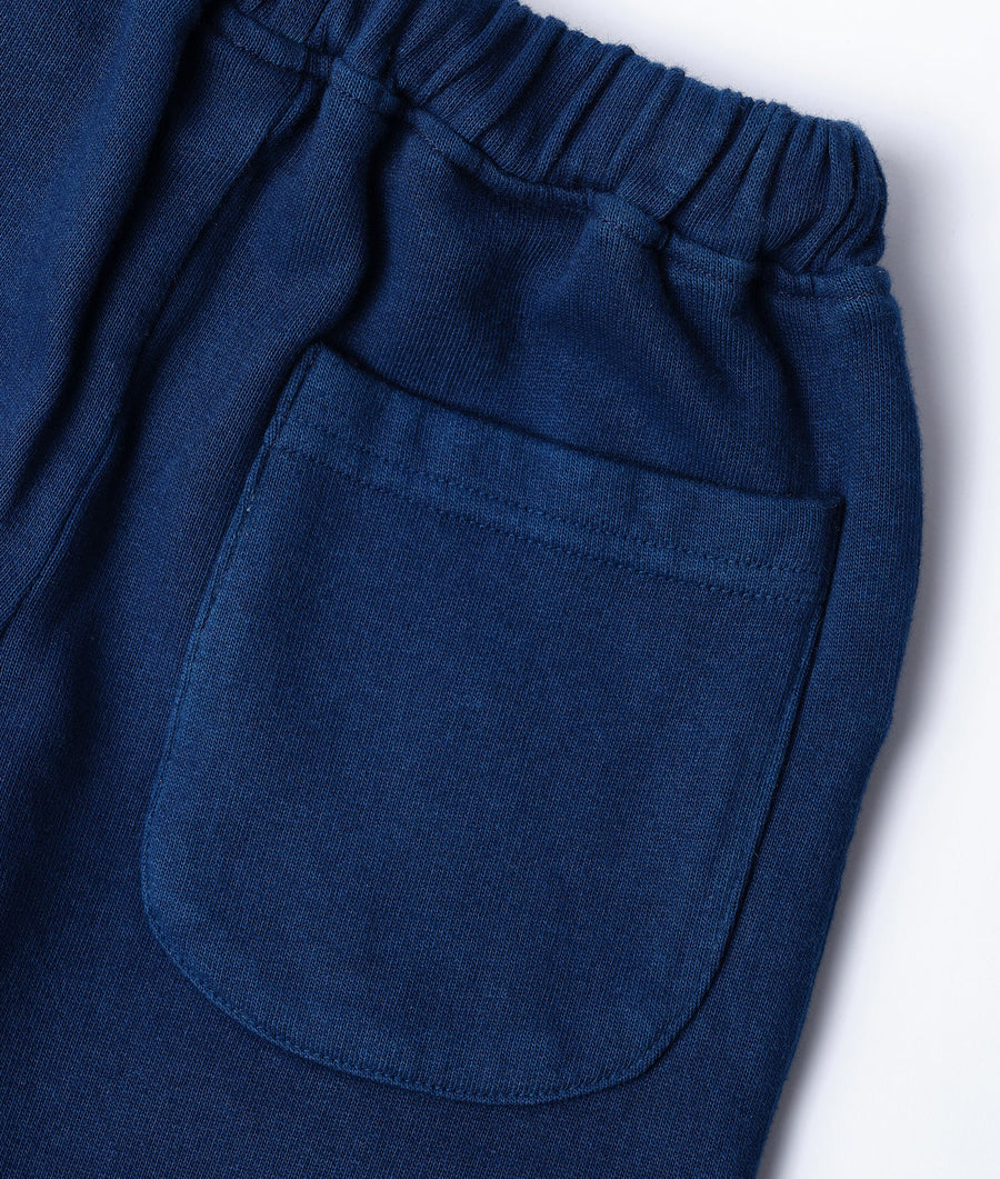 Detail shot of navy blue organic cotton shorts with drawstring waist and pockets - Industry of All Nations