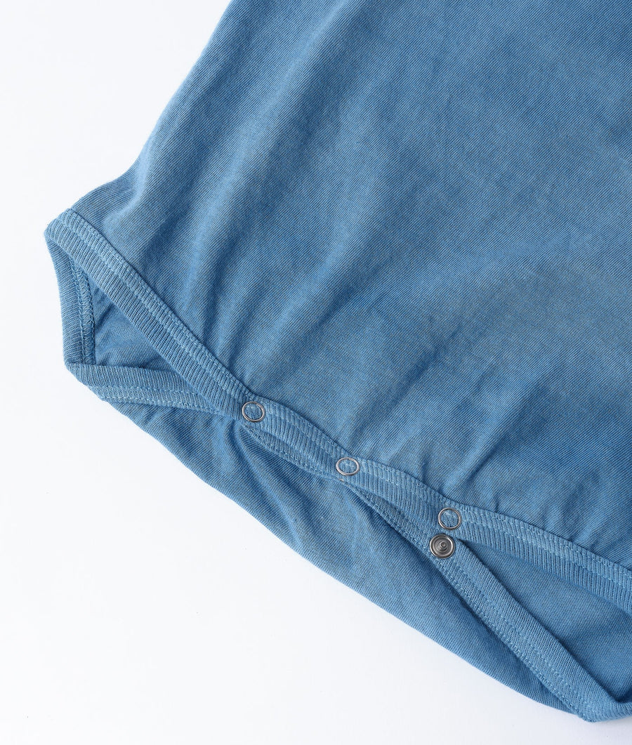 Detail shot of a blue organic cotton button-down shirt with metal buttons - Industry of All Nations