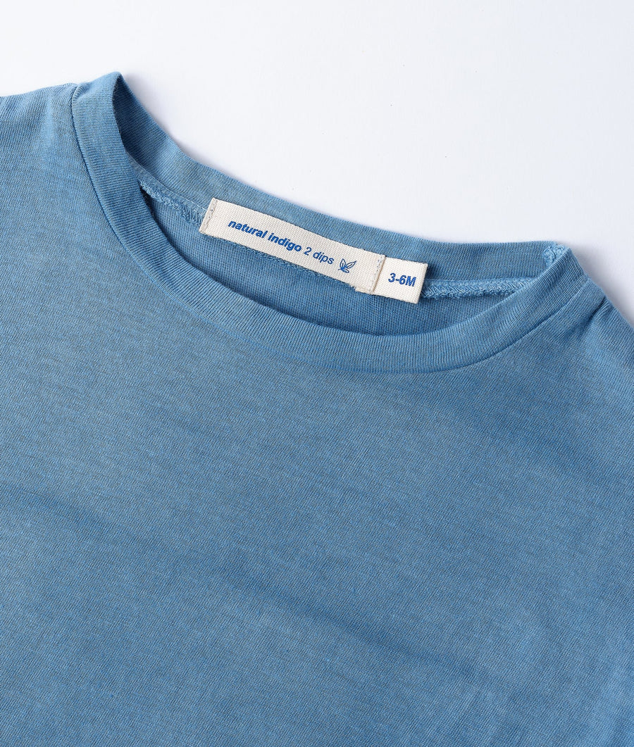 Close-up of a blue organic cotton t-shirt from Industry of All Nations.