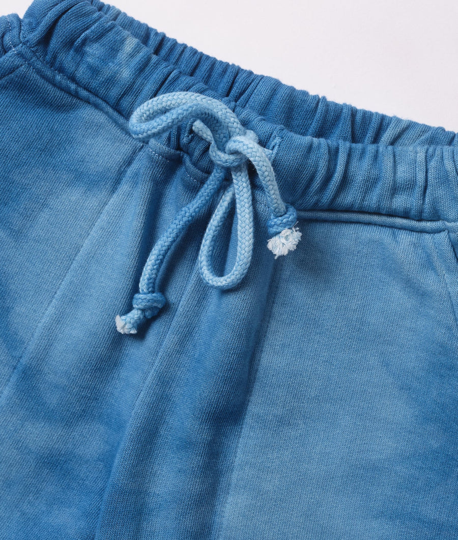 Close-up of blue cotton drawstring shorts with ruched waistband and drawstring tie - Industry of All Nations
