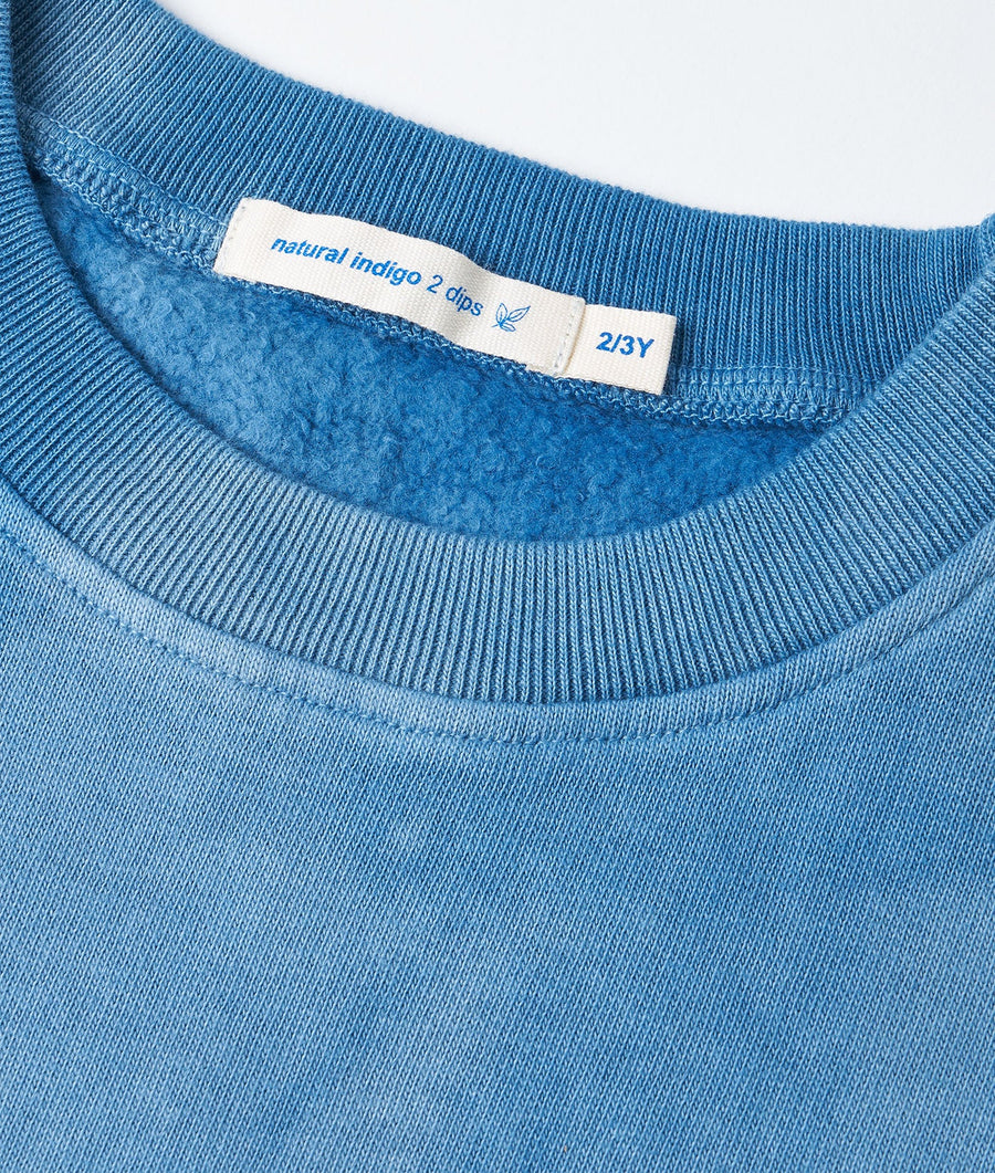 Detail shot of a blue organic cotton t-shirt with a natural indigo 2 dips label - Industry of All Nations