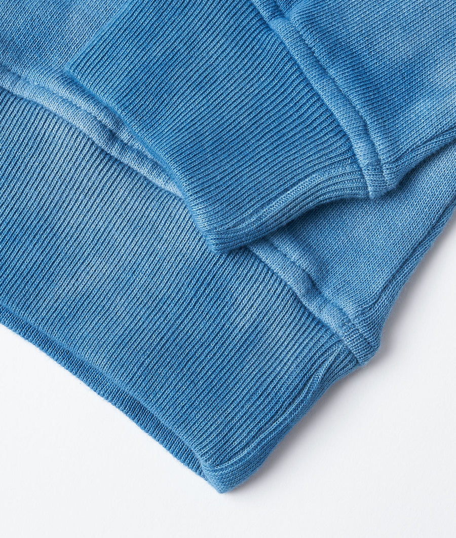 Close-up of a blue ribbed knit sweater with textural stitching - Industry of All Nations