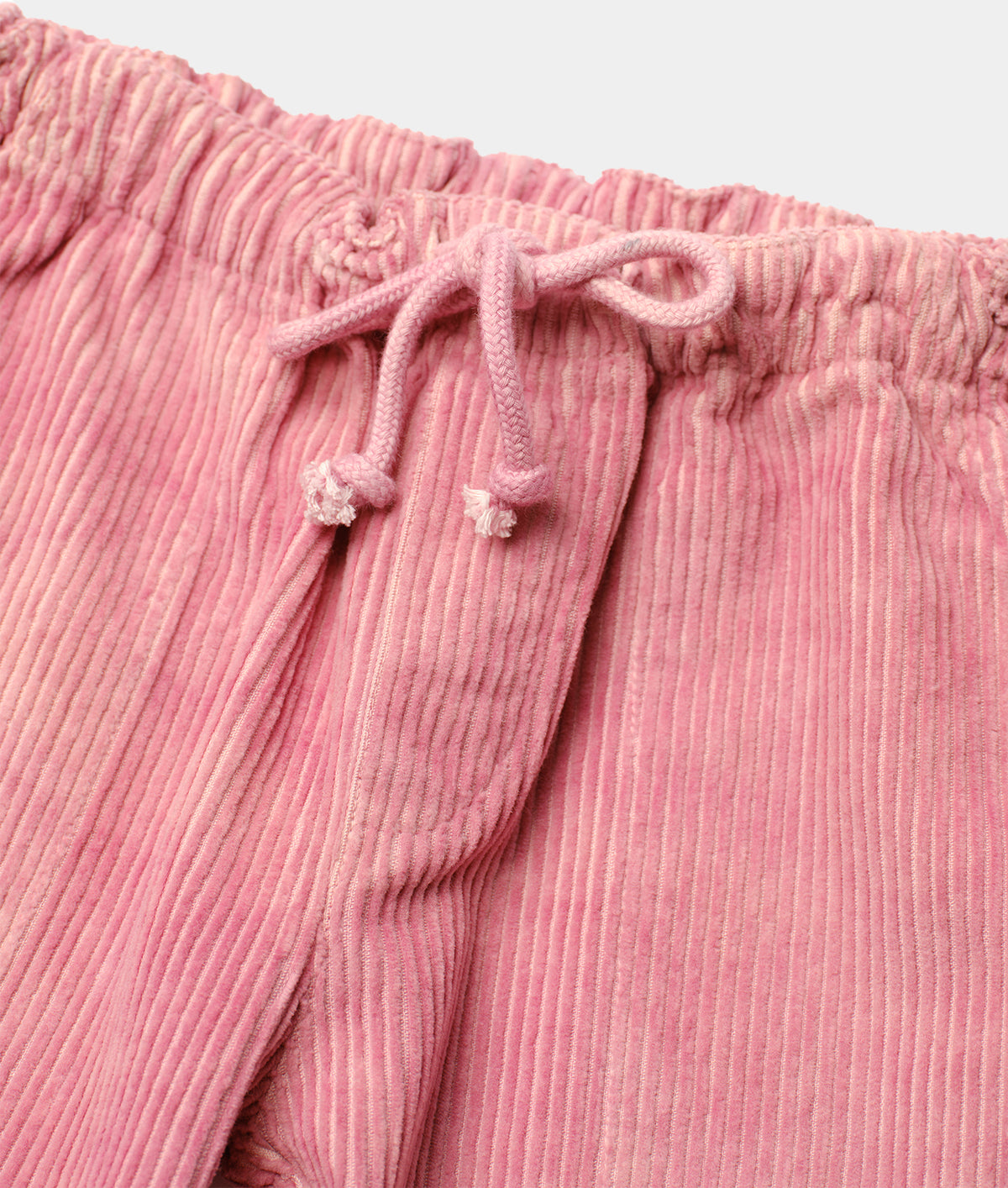 Close-up detail shot of a pink pleated cotton skirt with drawstring waist - Industry of All Nations