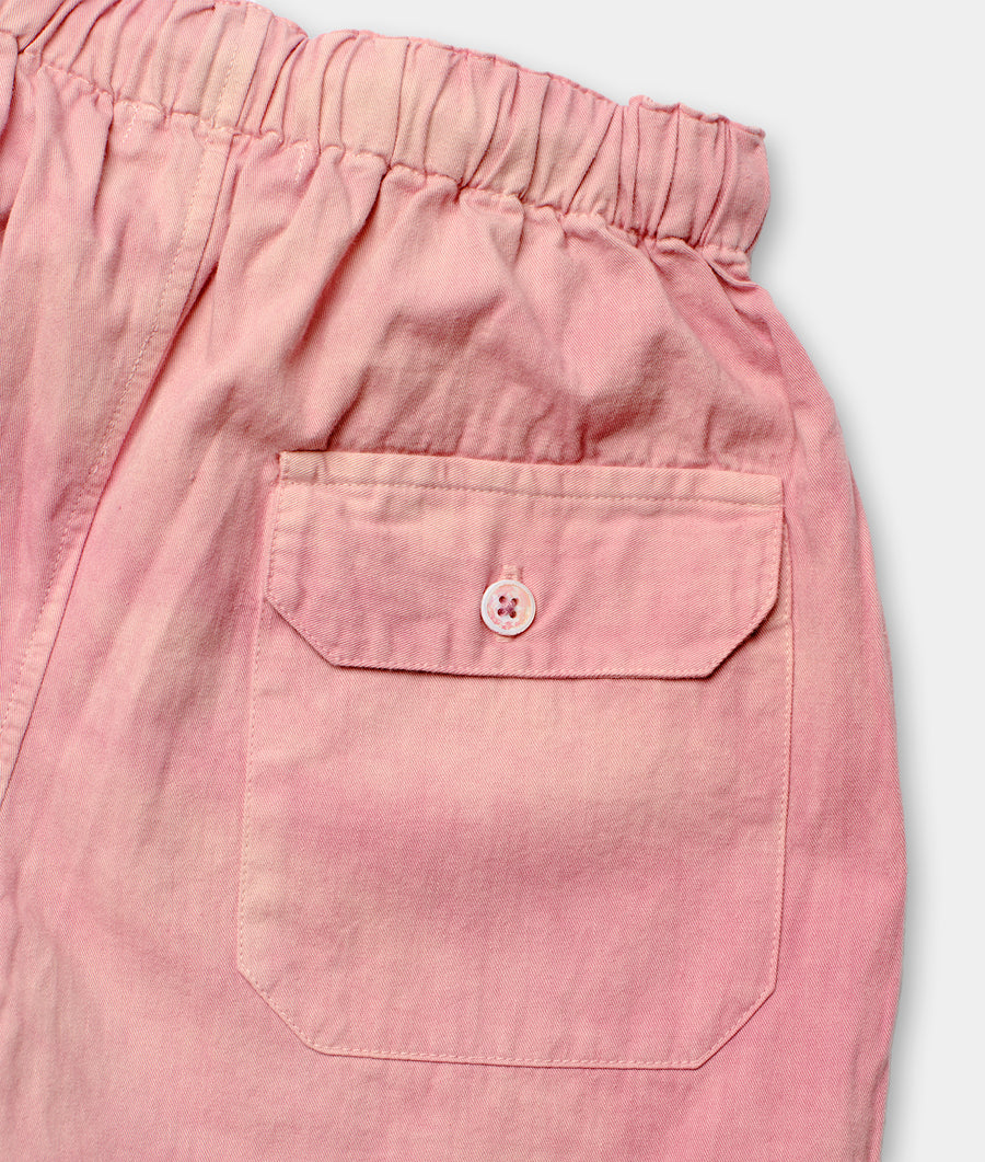 Close-up detail shot of a pair of pink cotton drawstring shorts with a single pocket - Industry of All Nations
