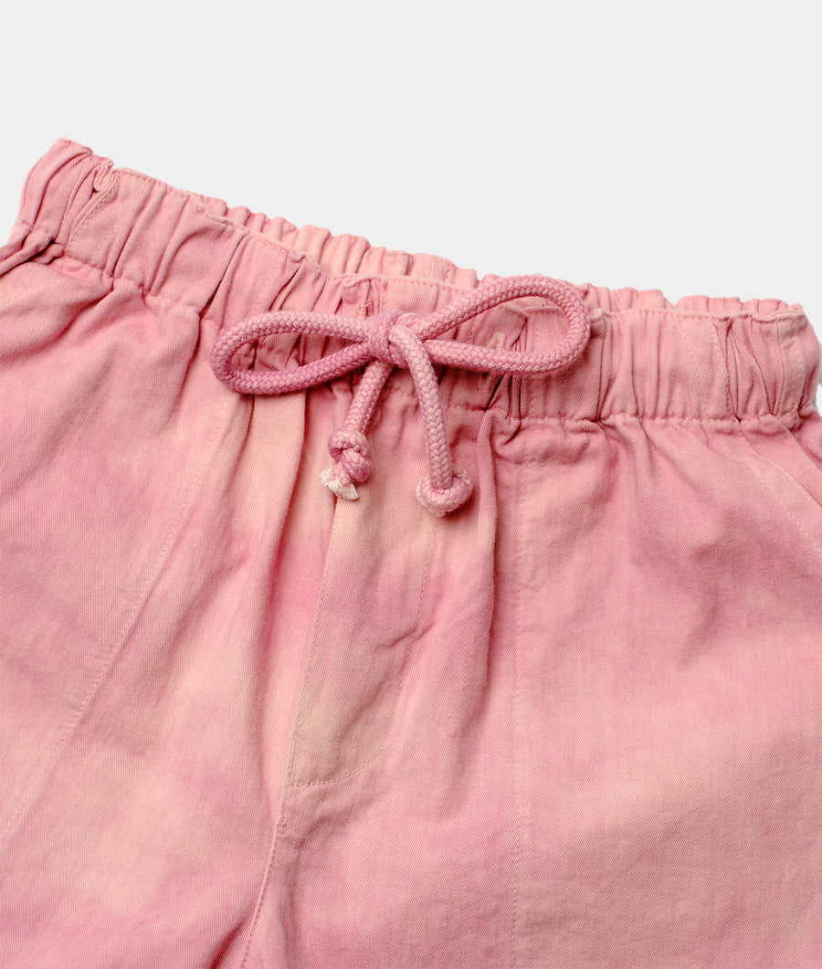 Close-up of drawstring waistband on a pink, ruched shorts from Industry of All Nations.