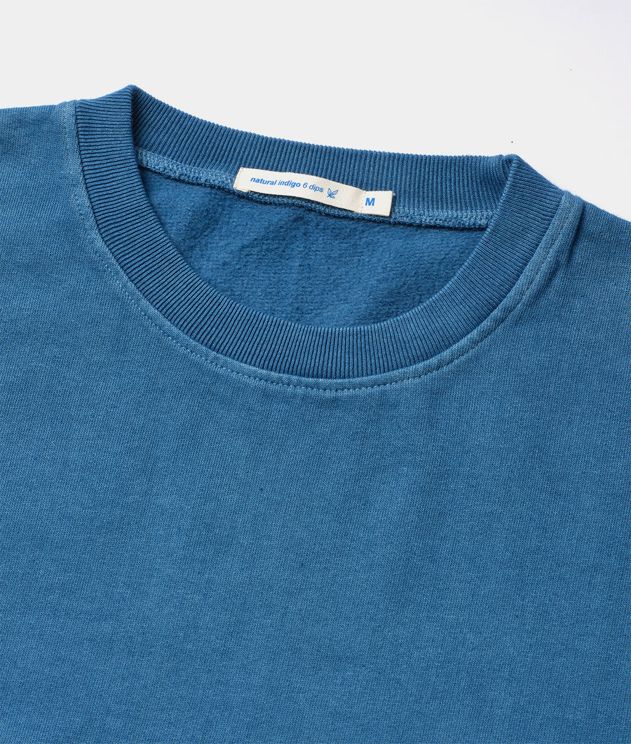 Detail shot of a blue organic cotton sweater with ribbed trim - Industry of All Nations