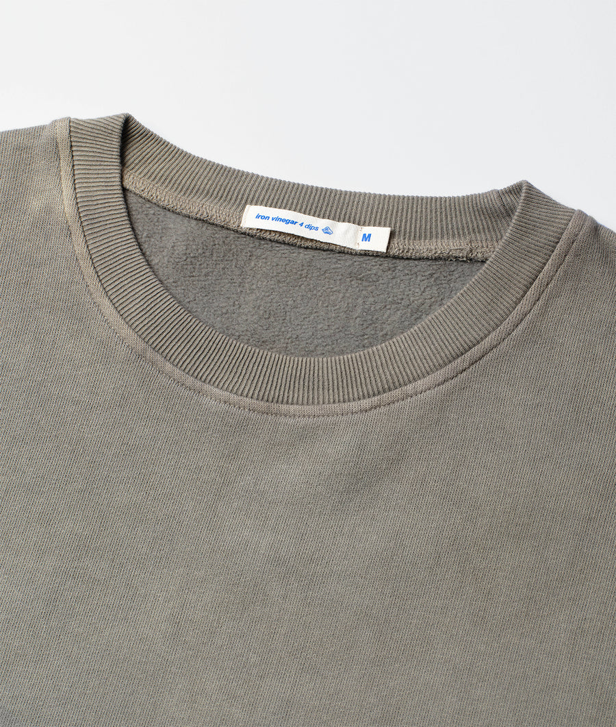 Detail shot of a gray crewneck sweater with a ribbed collar and cuffs - Industry of All Nations