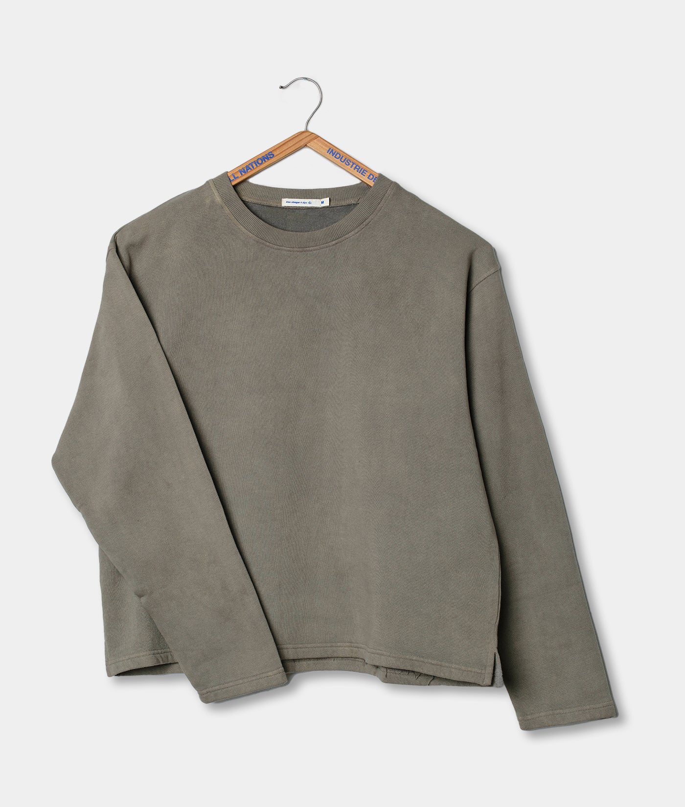 Grey sweatshirt on a hanger against a light background