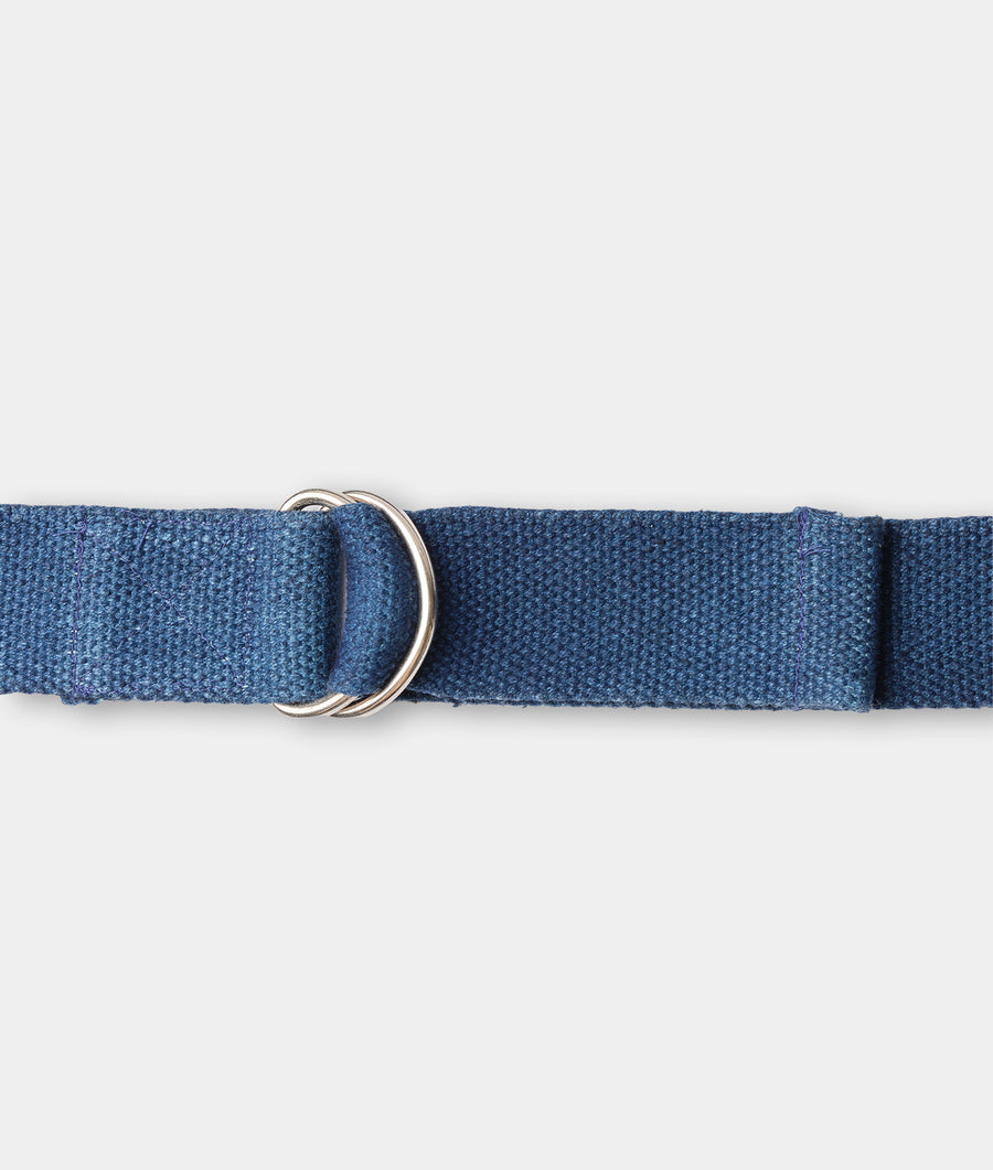 Close-up of a navy blue woven cotton belt with metal D-ring buckle - Industry of All Nations