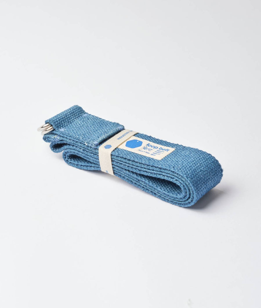 A bundle of teal blue knitted socks displayed on a plain background - Industry of All Nations