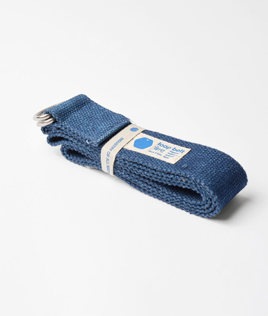 A rolled-up dark blue woven cotton belt with a tag that says "food belt" - Industry of All Nations