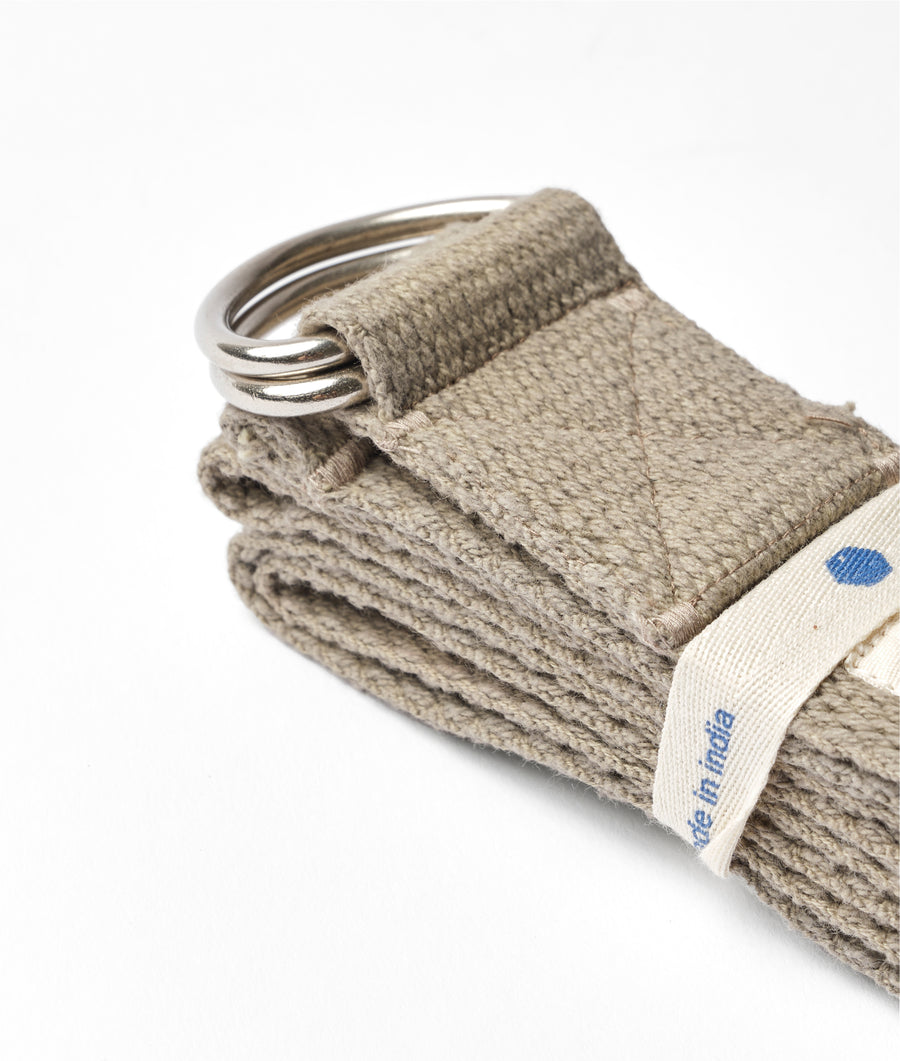 A close-up detail shot of a beige, woven cotton keychain with metal rings - Industry of All Nations
