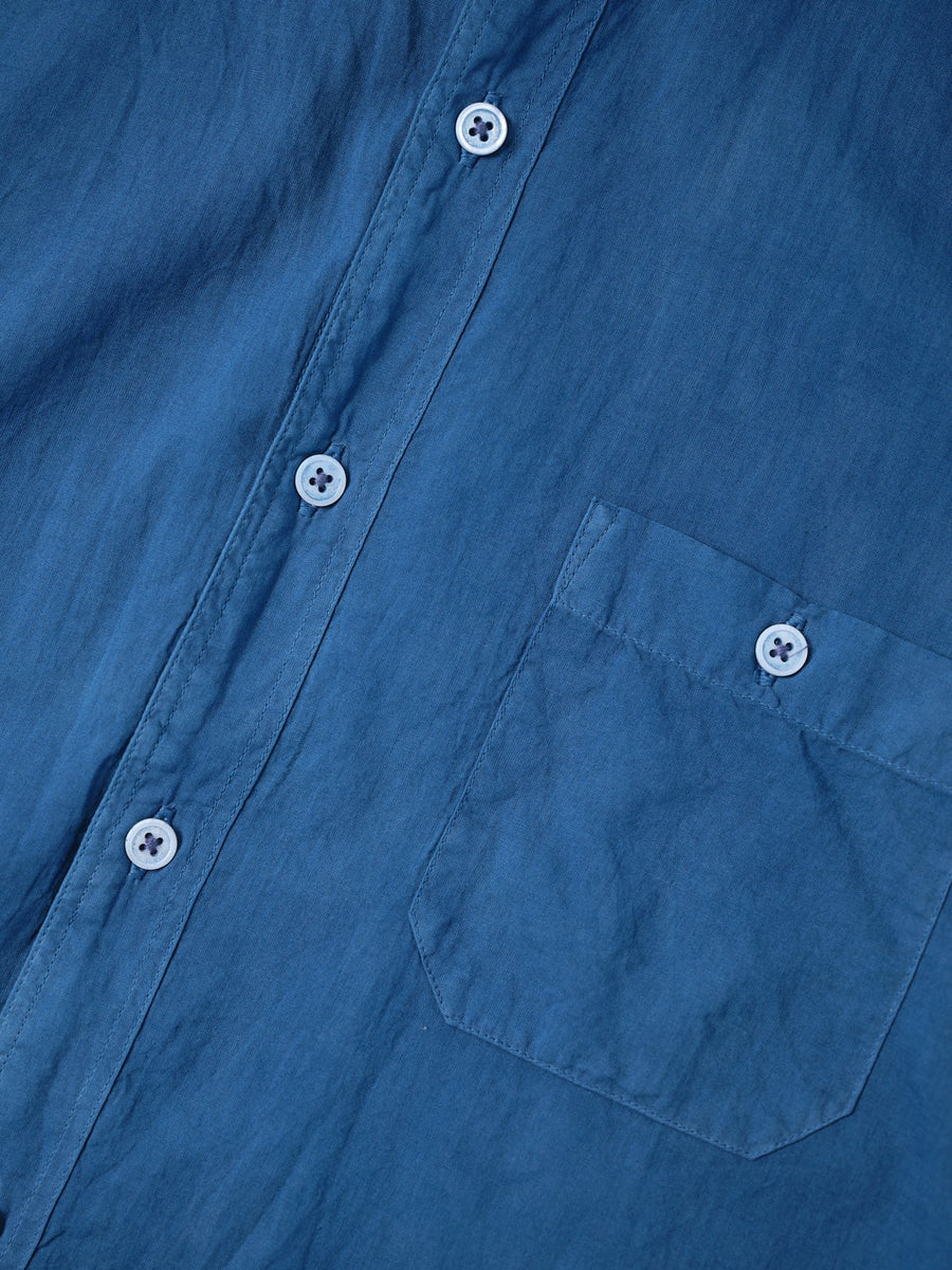 Detail shot of a navy blue organic cotton button-down shirt with a chest pocket - Industry of All Nations