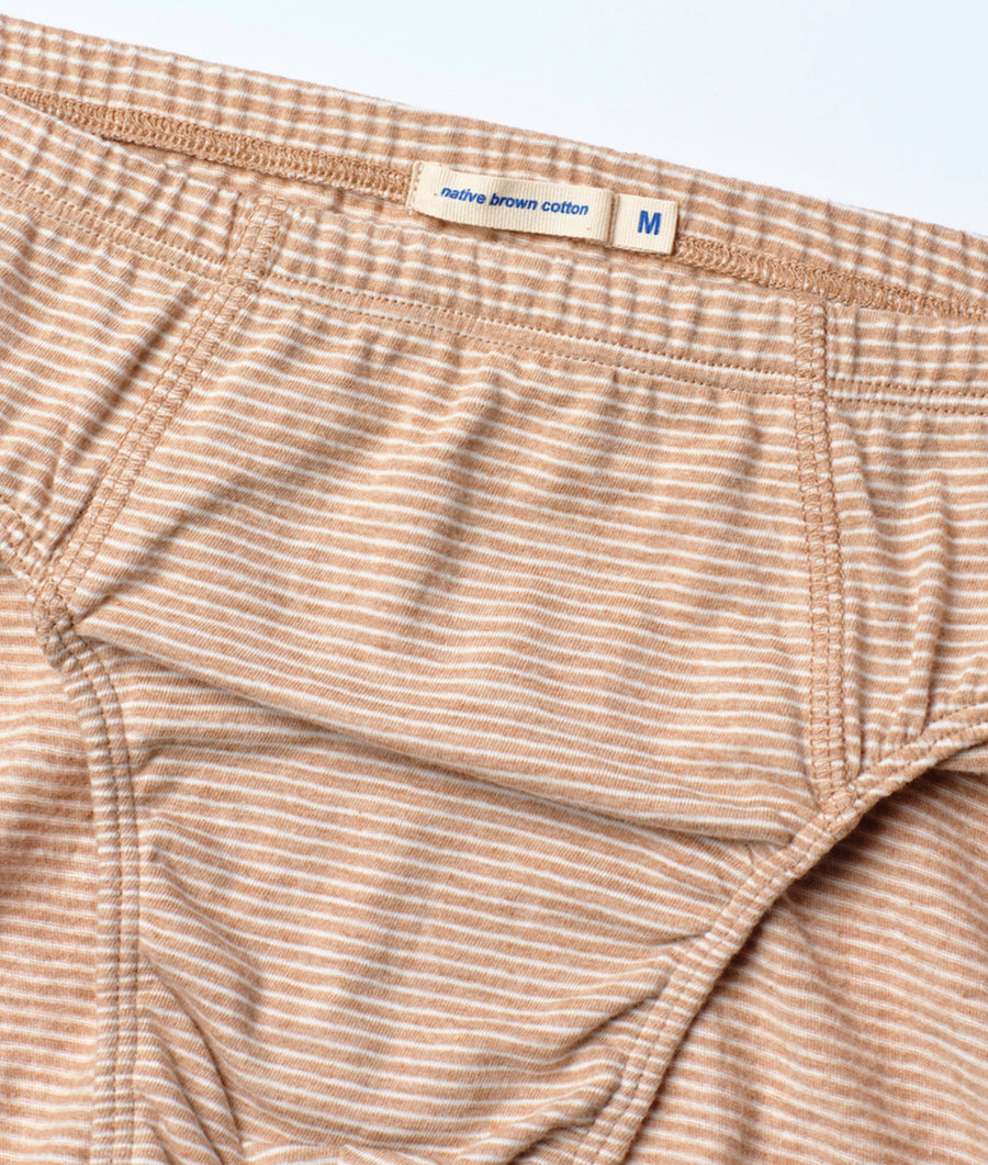 Close-up detail shot of tan and white striped cotton boxer briefs from Industry of All Nations.