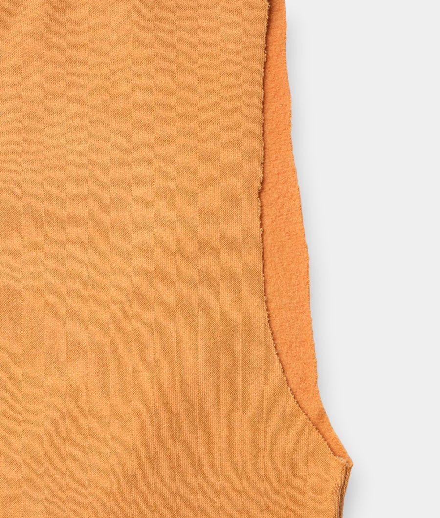 Detail shot of a soft peach-colored organic cotton sweatshirt from Industry of All Nations.