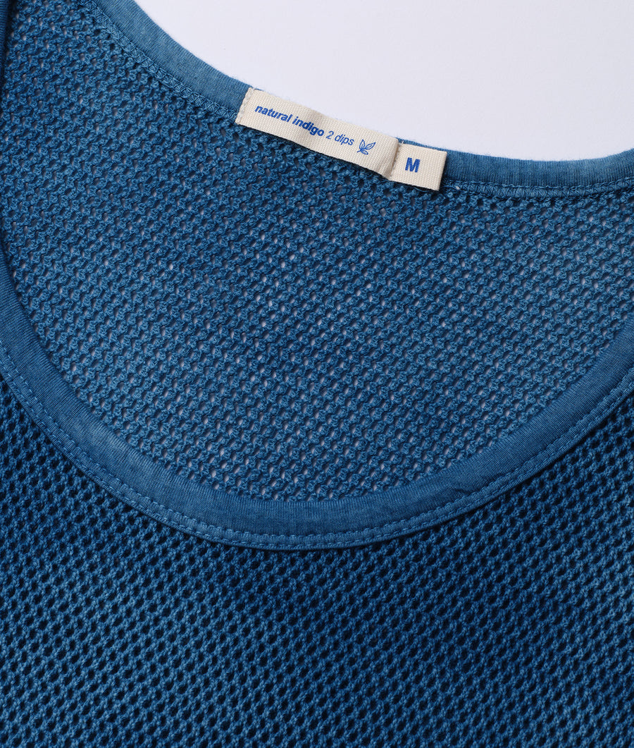 Close-up detail shot of a blue knit crewneck sweater with a Natural Indigo 2 dips label - Industry of All Nations