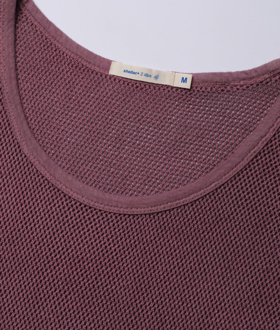 A close-up detail shot of a burgundy waffle knit shell top with a "shellac+ 2 dips" label - Industry of All Nations