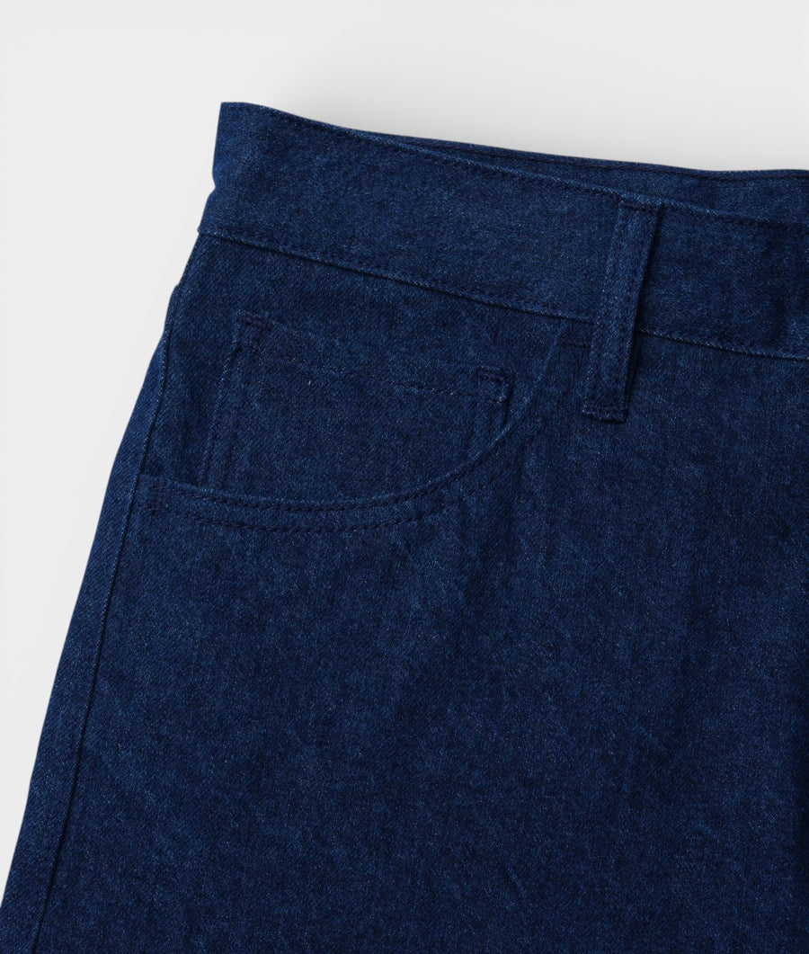 Detail shot of dark blue denim pants with pockets - Industry of All Nations