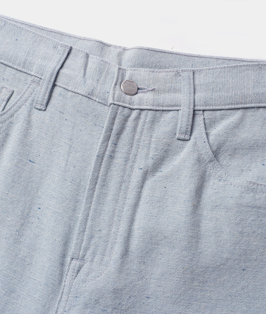 Detail shot of gray denim pants with single silver button closure - Industry of All Nations