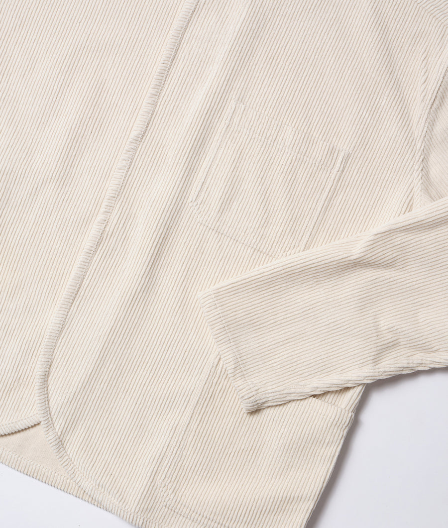 Close-up photograph of a beige organic cotton corduroy long sleeve shirt displayed flat - Industry of All Nations