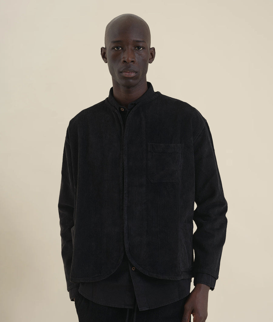 A Black corduroy jacket worn by a male model - Industry of All Nations