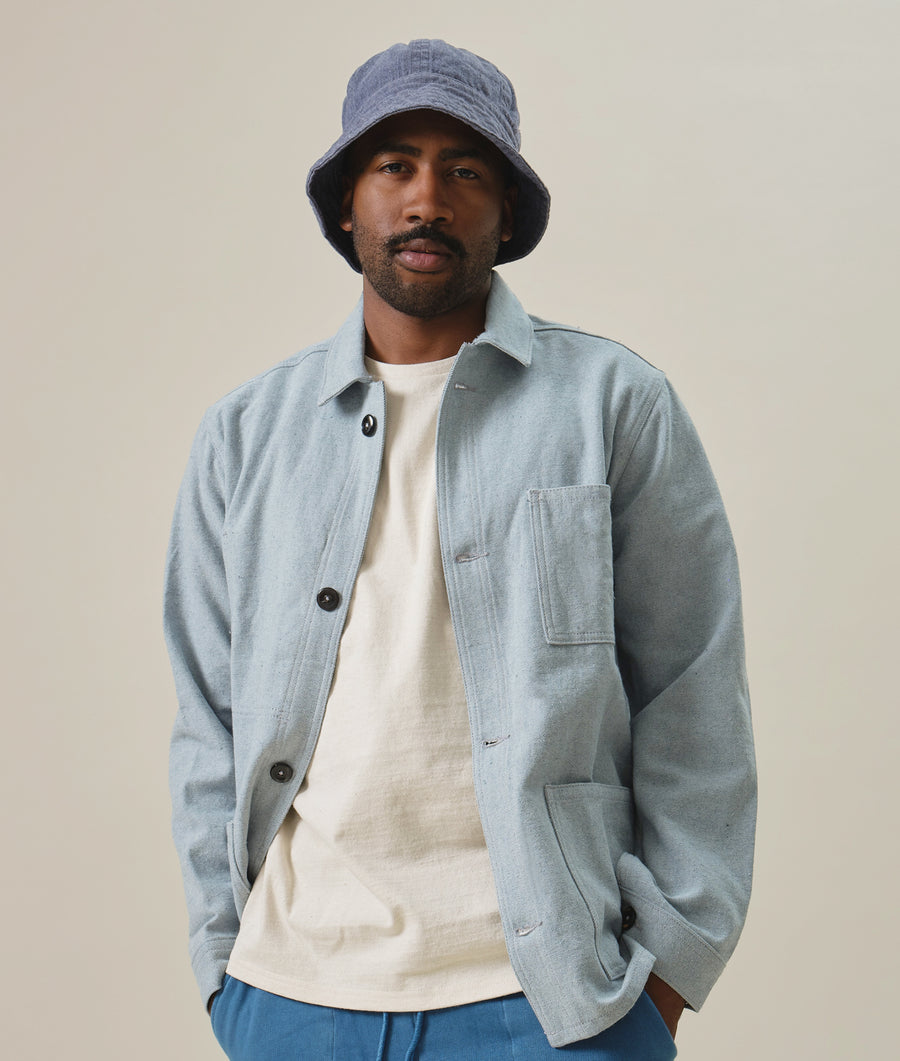 Gray fleece jacket worn by a man in a neutral setting - Industry of All Nations