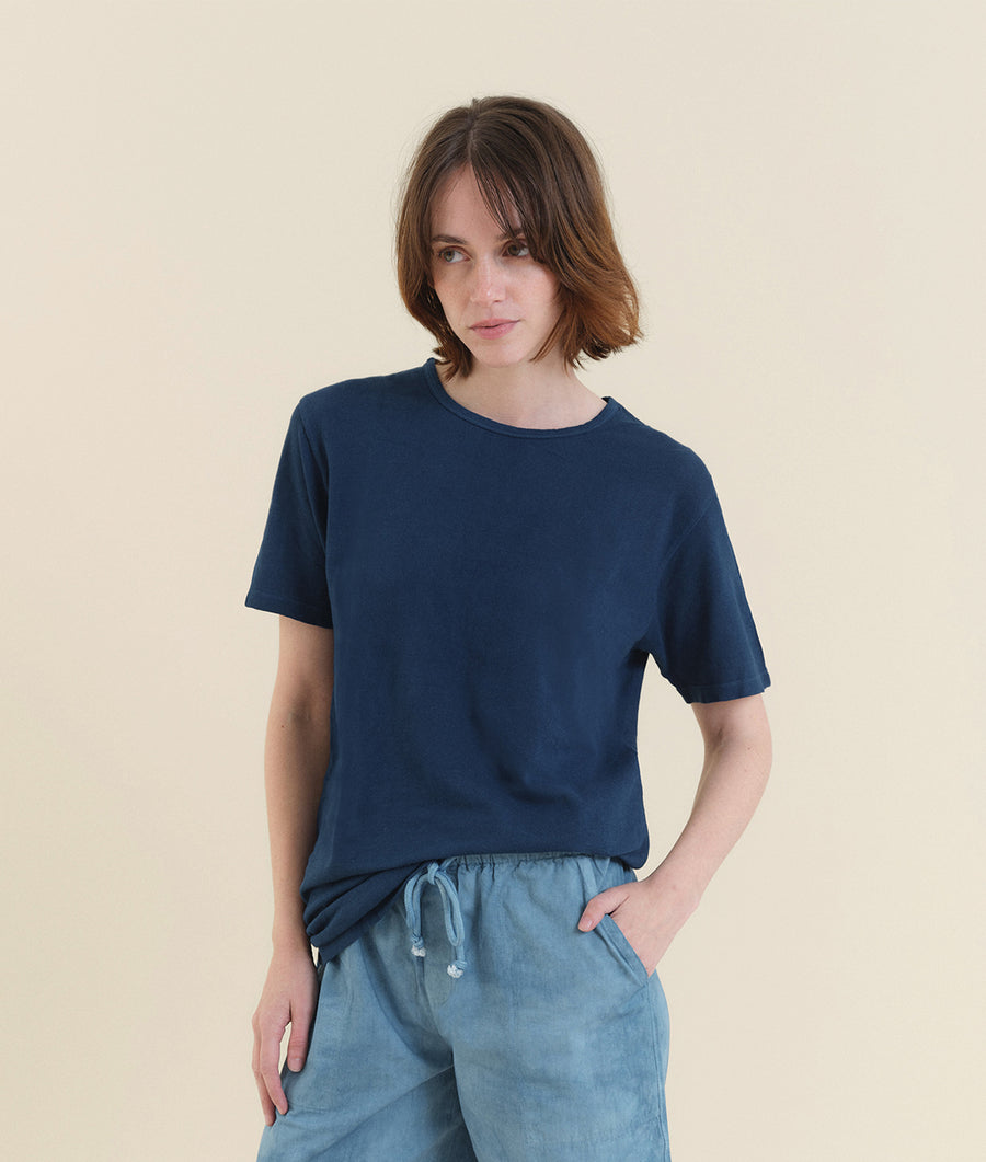 Navy blue short-sleeve cotton t-shirt worn by a woman with short, dark hair - Industry of All Nations