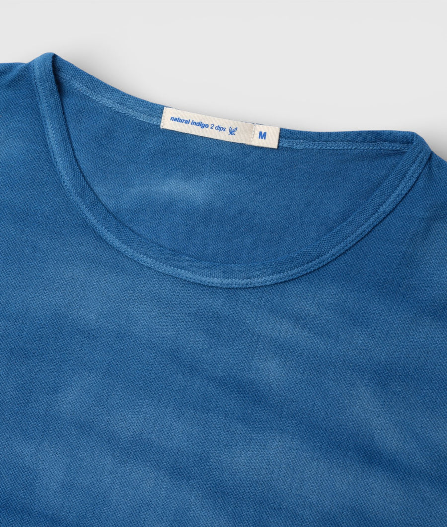 Closeup detail of a blue natural indigo 2-dip crew neck t-shirt from Industry of All Nations.
