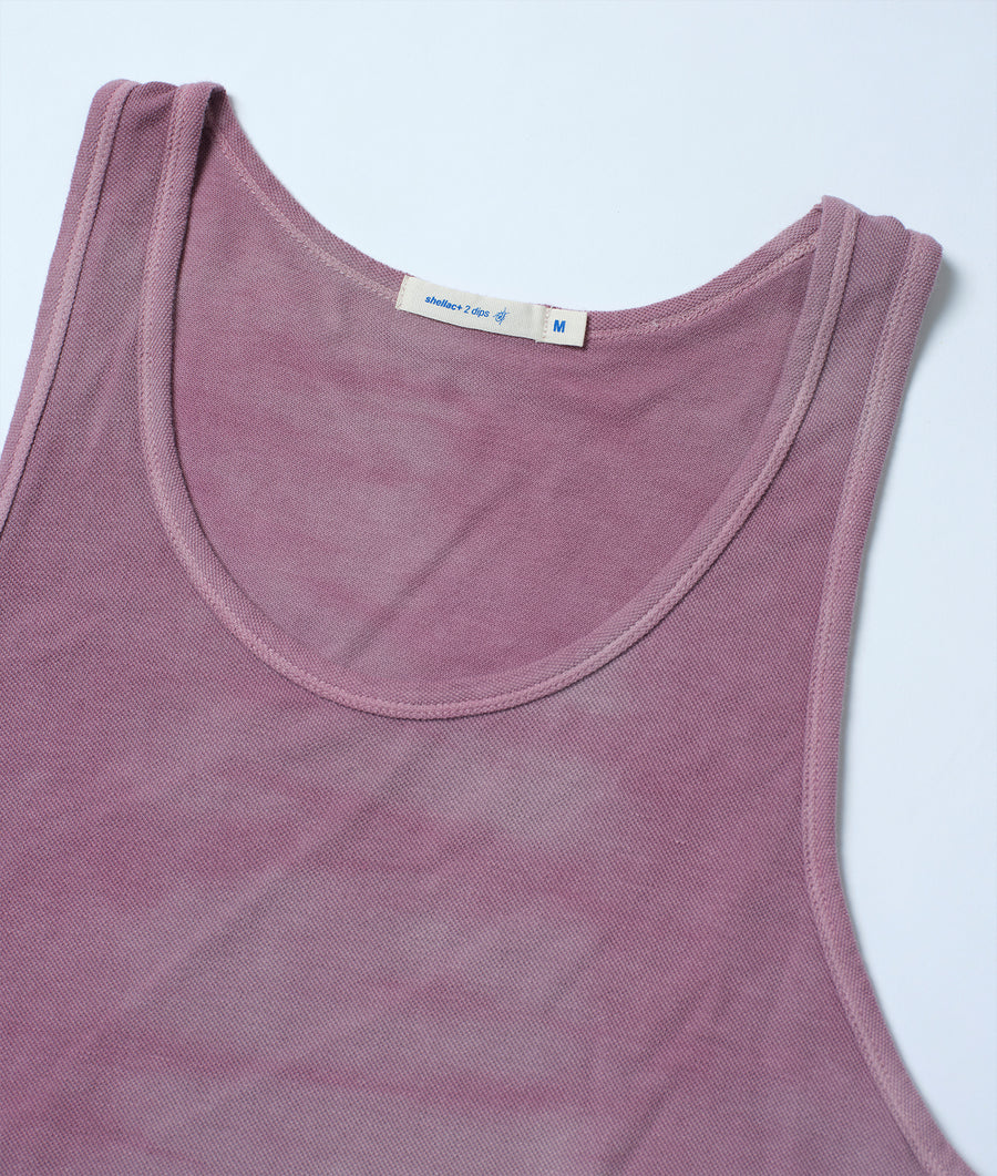 A close-up detail shot of a medium-sized solid-colored sleeveless pink tank top with a simple neck design - Industry of All Nations