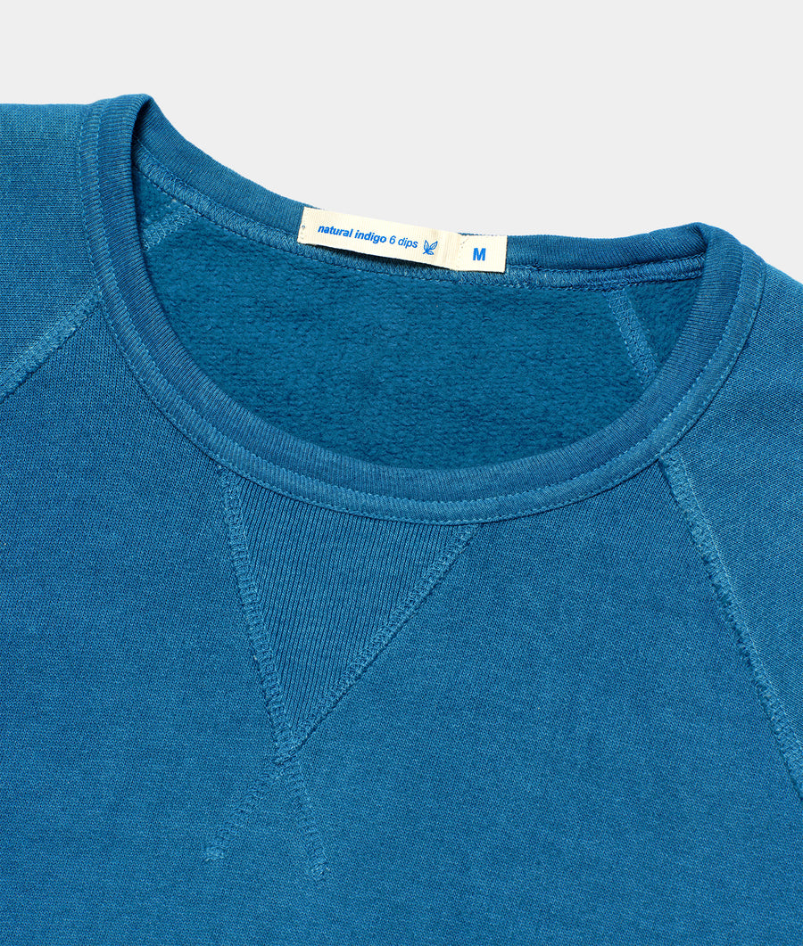 Close-up of a navy blue organic cotton long-sleeved shirt with natural indigo dye details - Industry of All Nations