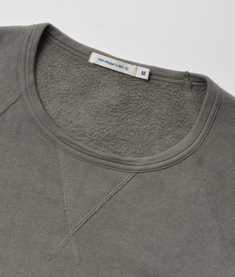 Closeup detail of a gray pullover sweater made of recycled cotton with a fleece interior - Industry of All Nations