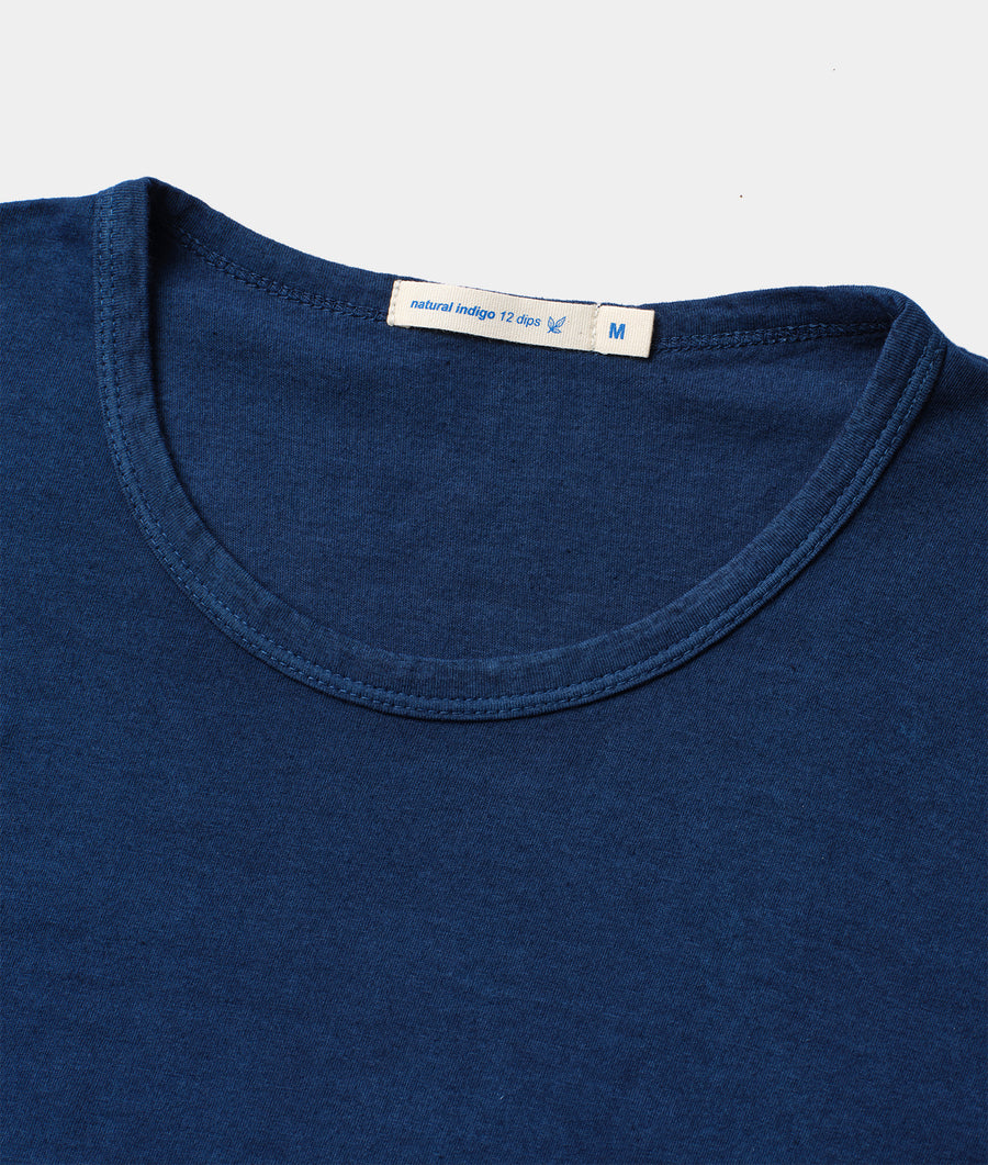 Navy blue 100% organic cotton t-shirt, close-up detail shot showing natural indigo dye and size tag - Industry of All Nations