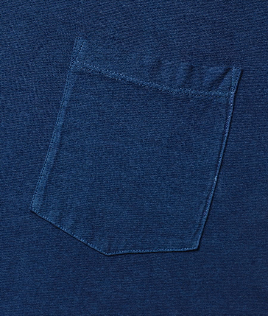 A close-up image of the pocket detail of a navy blue cotton garment - Industry of All Nations