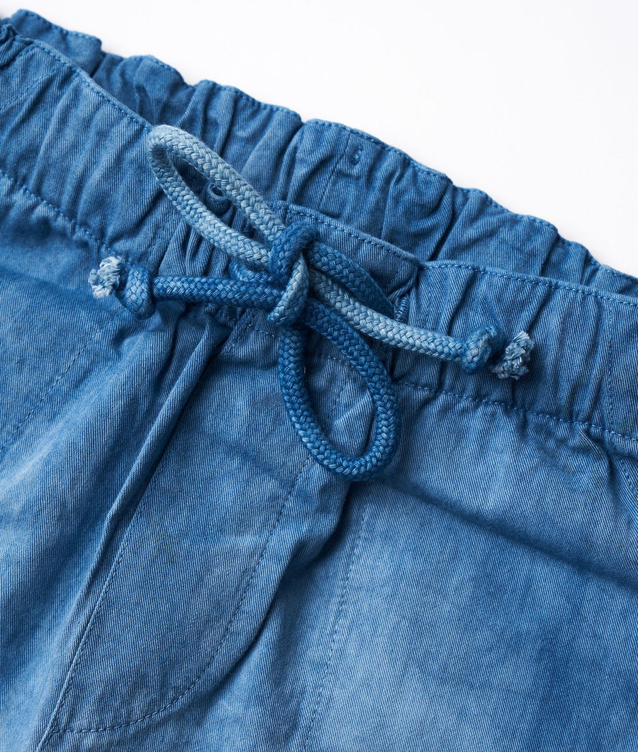 Close-up detail shot of blue cotton shorts with drawstring waist from Industry of All Nations.