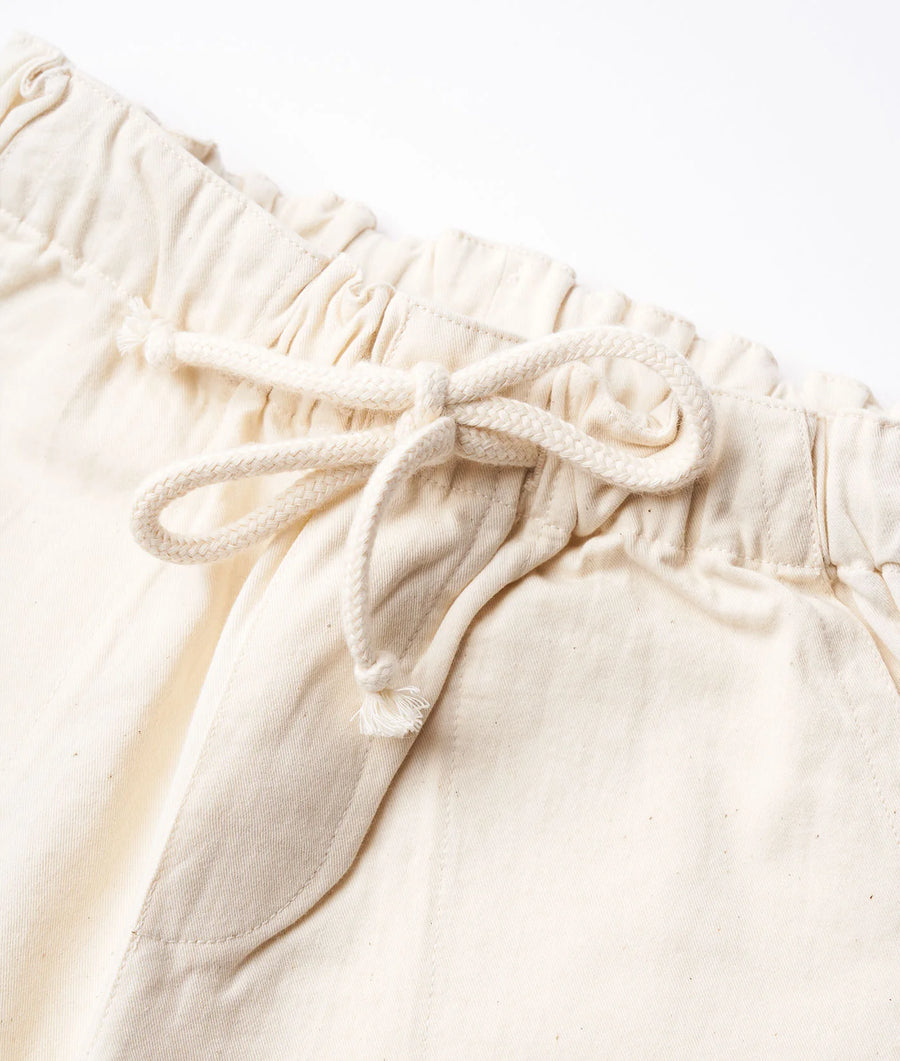 Detail shot of cream-colored drawstring waist pants - Industry of All Nations
