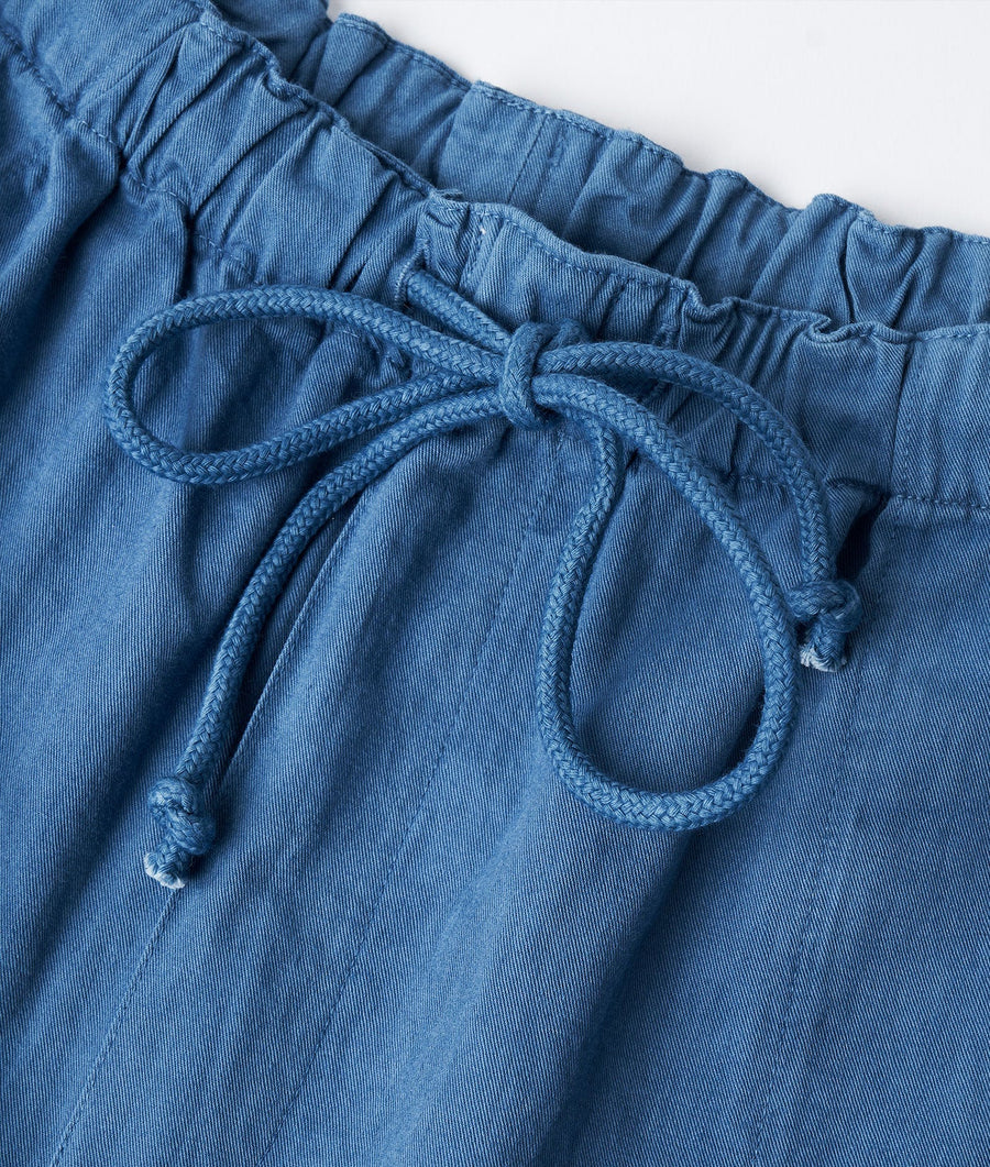 Flat lay of a blue drawstring waist pant with braided cord detail - Industry of All Nations