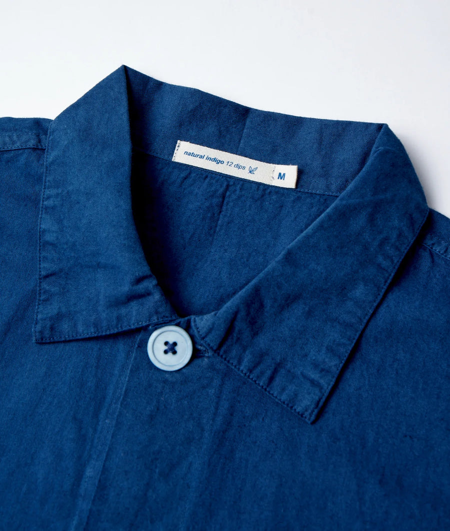 Closeup of a navy blue, 100% organic cotton button-down shirt with a Natural Indigo 12 dips label - Industry of All Nations.
