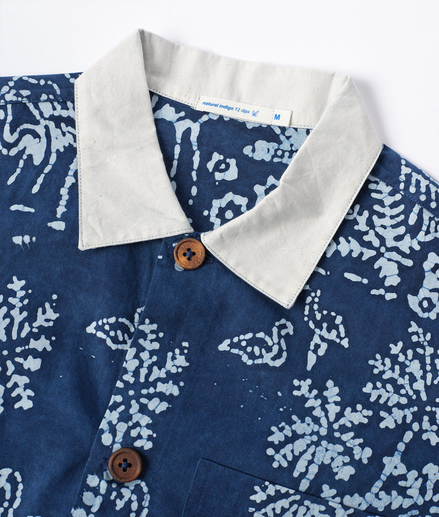 Blue and white patterned button-down shirt displayed flat with wooden buttons - Industry of All Nations